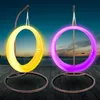 Two illuminated hanging chairs on a wooden deck at dusk. Produktbild-Vorschau