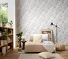 A cozy living room scene with a sofa, bookshelf, and patterned wallpaper. Podgląd zdjęcia produktu