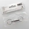 A product package containing a silver key ring coupling. Produktbild-Vorschau
