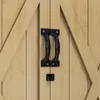 A close-up view of a wooden cabinet door with black handles. Náhľad obrázku produktu