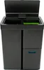 A black sensor recycler bin with its lid open, showing two compartments inside. One compartment is black, and the other has a green insert. Below the main bin, there is a smaller drawer with a blue handle. Produktbild-Vorschau