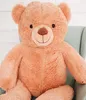 A large, plush teddy bear is sitting in a light green armchair. Produktbild-Vorschau