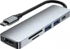 A silver USB-C hub adapter with multiple ports, including HDMI, USB 3.0, SD card reader, and USB-C PD. It is shown on a white background with a black cable extending from the USB-C connector. Produktbild-Vorschau