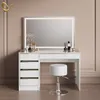 A white vanity table with a lighted mirror and a stool, set against a light brown wall. Produktbild-Vorschau
