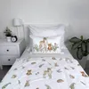 A child's bed with white bedding featuring a woodland animal print. Produktbild-Vorschau