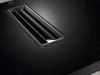 A close-up view of a black induction cooktop with a ventilation grille. Podgląd zdjęcia produktu