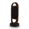 A modern-looking fan and heater with a dark brown base, a dark brown oval heating/cooling element, and a light brown loop-like handle. Anteprima dell’immagine prodotto