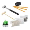 A collection of items for a Zen garden, including rakes, candles, stones, and sand. Náhled obrázku produktu
