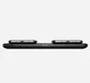 A black wireless charging pad with two smartphones on top, shown from a side view against a white background. Voir les images du produit