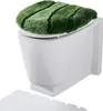 A toilet seat cover with a green, striped, plush design is placed on a white toilet. Produktbild-Vorschau