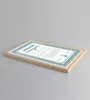 A framed certificate is shown at an angle on a plain gray background. Produktbild-Vorschau