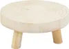 A small, round wooden plant stand with three legs. Voir les images du produit