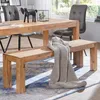 A wooden dining bench with a knitted throw draped over it, placed in a dining room setting with a wooden table and chairs. Anteprima dell’immagine prodotto