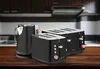 A black electric kettle and two black toasters with wood accents are displayed on a wooden table in a kitchen setting. Voir les images du produit