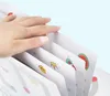 A hand is shown flipping through a set of flashcards with cartoon illustrations. Podgląd zdjęcia produktu