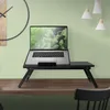 A laptop table is set up on a wooden shelf in a room with a light green wall and a large clock. Produktbild-Vorschau