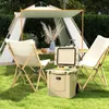 A camping setup with a tent, table, chairs, and a cooler. Podgląd zdjęcia produktu