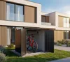 A red bicycle is stored in a black metal bike shed next to a modern house. Produktbild-Vorschau
