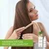 A woman is shown combing her long brown hair, with product packaging and a spray bottle visible on the right side of the image. Produktbild-Vorschau