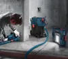 A person is using a Bosch tool connected to a vacuum cleaner in a construction environment. Náhled obrázku produktu