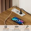 A close-up view of a power strip integrated into a wooden surface, with a smartphone charging. Produktbild-Vorschau