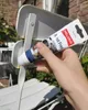 A hand is holding a tube of rust remover product next to a white metal chair with rust spots. Produktbild-Vorschau