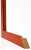 A close-up, angled view of a corner of an orange picture frame, showing the mitered joint and the raw MDF material on the inside edge. Produktbild-Vorschau