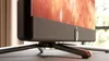 Close-up of the bottom part of a television set, showing its stand and part of the screen. Produktbild-Vorschau