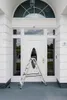 A white double door with glass panels and an arched window above, with a silver ladder placed in front of the door. Anteprima dell’immagine prodotto