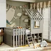 A child's bedroom with a house-shaped loft bed, decorated with playful wall art and soft toys. Náhľad obrázku produktu