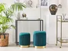 Two teal velvet poufs with gold trim are placed in a living room setting next to a console table and a plant. Náhled obrázku produktu