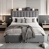 A modern bedroom with a grey upholstered bed as the main focus. Anteprima dell’immagine prodotto