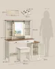 A diagram showing the dimensions of a vanity table and stool, with a silhouette of a person for scale. Produktbild-Vorschau