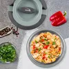 A lunchbox with food, ingredients, and spices arranged around it. Náhled obrázku produktu