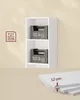 A white shelf unit against a cream-colored wall, with weight indicators and a thickness measurement shown. Produktbild-Vorschau