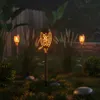 Solar-powered LED torches with a flame effect are illuminating a garden at night. Náhled obrázku produktu