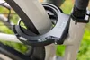 A close-up shot of a bicycle lock attached to the frame and wheel. Produktbild-Vorschau