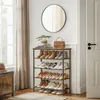 An entryway with a shoe rack filled with shoes, a mirror on the wall, and a handbag on top of the shoe rack. Náhled obrázku produktu