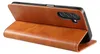A brown leather flip case for a smartphone is shown standing upright. Produktbild-Vorschau