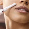 A close-up shot of a person's face, focusing on the area around the mouth, as a facial hair trimmer is used. Náhled obrázku produktu