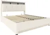 A beige upholstered bed frame with a slatted base, shown from a diagonal angle against a white background. Podgląd zdjęcia produktu