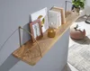 A wooden shelf mounted on a gray wall, decorated with books, a picture frame, and a small lamp. Podgląd zdjęcia produktu