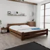 A bedroom scene with a wooden bed. Produktbild-Vorschau