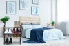A bedroom scene with a shoe rack in the foreground. Voir les images du produit