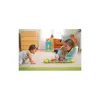 A woman and a baby are playing with a musical worm toy on the floor. Produktbild-Vorschau
