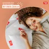 A woman is lying on pillows, looking at the camera with a smile. Produktbild-Vorschau