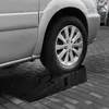 A car tire is on a black plastic ramp. Podgląd zdjęcia produktu