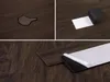 A collage of three images showing vinyl flooring planks. One image shows a water spill on the flooring, another shows the adhesive backing being peeled off a plank, and the third shows several planks with the backing partially peeled. Podgląd zdjęcia produktu