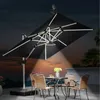 An outdoor patio scene at dusk with a large cantilever umbrella providing light over a table and chairs. Anteprima dell’immagine prodotto