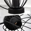 Close-up views of the base and socket of a black, wire-frame lamp. Produktbild-Vorschau